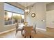 Bright breakfast nook features backyard views, a modern chandelier and a neutral palette at 7928 E Parkview Ln, Scottsdale, AZ 85255