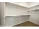 Bright closet featuring built-in shelving and neutral carpeting at 7928 E Parkview Ln, Scottsdale, AZ 85255