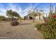 Single-story home with desert landscaping, mature trees, and a gravel yard at 7928 E Parkview Ln, Scottsdale, AZ 85255