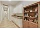 Hallway with white cabinetry, a bookshelf, and a view to the bathroom at 7928 E Parkview Ln, Scottsdale, AZ 85255
