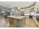 Modern kitchen with a large center island, stainless steel appliances, and pendant lighting at 7928 E Parkview Ln, Scottsdale, AZ 85255