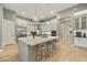 Modern kitchen with a large center island, stainless steel appliances, and pendant lighting at 7928 E Parkview Ln, Scottsdale, AZ 85255