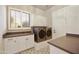 Well-lit laundry room featuring modern appliances, ample counter space, and attractive tile flooring at 7928 E Parkview Ln, Scottsdale, AZ 85255