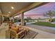 Inviting covered patio with lounge seating, a manicured lawn, and a sparkling pool for outdoor enjoyment at 7928 E Parkview Ln, Scottsdale, AZ 85255