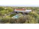 Aerial view of desert home with large covered patio, outdoor seating, and a beautiful pool at 7928 E Parkview Ln, Scottsdale, AZ 85255