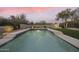 Desert oasis featuring a sparkling pool surrounded by lush greenery and desert landscaping at 7928 E Parkview Ln, Scottsdale, AZ 85255