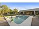 Stunning backyard pool features baja step, desert landscaping, and lush greenery for a serene outdoor retreat at 7928 E Parkview Ln, Scottsdale, AZ 85255