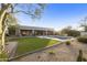 Inviting backyard with a lush lawn, refreshing pool, desert landscaping and expansive covered patio at 7928 E Parkview Ln, Scottsdale, AZ 85255