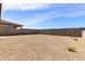 Wide backyard with desert landscaping and privacy provided by a block fence at 18197 W Cielo Grande Ave, Surprise, AZ 85387