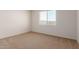 Neutral-toned bedroom with carpet flooring, one window, and white walls at 18197 W Cielo Grande Ave, Surprise, AZ 85387