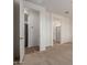 Neutral bedroom with a carpeted floor and an open door to the bathroom and closet at 18197 W Cielo Grande Ave, Surprise, AZ 85387