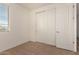 Well-lit bedroom with neutral carpet, large window, and closet with sliding doors at 18197 W Cielo Grande Ave, Surprise, AZ 85387