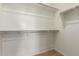 White walk-in closet with shelving for clothing and storage, with carpeted floor at 18197 W Cielo Grande Ave, Surprise, AZ 85387