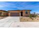 Single-story home featuring a two-car garage, low-maintenance landscaping, and a neutral color palette at 18197 W Cielo Grande Ave, Surprise, AZ 85387