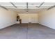 Spacious two car garage with a smooth concrete floor and white walls at 18197 W Cielo Grande Ave, Surprise, AZ 85387