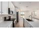 Modern kitchen with white cabinetry, stainless steel appliances, a large island, and stylish backsplash at 18197 W Cielo Grande Ave, Surprise, AZ 85387