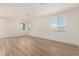 Spacious living room with natural light, wood-look tile flooring, and neutral walls at 18197 W Cielo Grande Ave, Surprise, AZ 85387