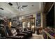 Home gym with leather seating, exercise equipment and sports memorabilia throughout at 19481 N 98Th Pl, Scottsdale, AZ 85255