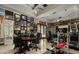 Spacious home gym with exercise equipment, office space, and sports memorabilia at 19481 N 98Th Pl, Scottsdale, AZ 85255