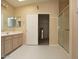 Bathroom featuring a vanity with double sinks and a separate glass-enclosed shower at 17316 N Inca Pl, Surprise, AZ 85374