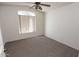 Cozy bedroom featuring a ceiling fan and window with vertical blinds at 17316 N Inca Pl, Surprise, AZ 85374