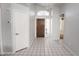 Foyer featuring tile floors, chandelier, and wood door at 17316 N Inca Pl, Surprise, AZ 85374