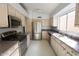 Spacious kitchen featuring stainless steel appliances, ample cabinetry, and tile floors at 17316 N Inca Pl, Surprise, AZ 85374