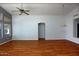 Bright living room with hardwood floors, ceiling fan, and large windows offering ample natural light at 17316 N Inca Pl, Surprise, AZ 85374