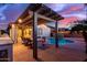 Relaxing poolside patio with a pergola and outdoor kitchen at 21950 N 100Th Ave, Peoria, AZ 85383