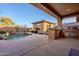 Relaxing backyard with pool, outdoor kitchen, and covered patio at 41515 N Chase Oaks Way, Anthem, AZ 85086