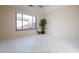 Bright bedroom with tile floors, large window, and ceiling fan at 41515 N Chase Oaks Way, Anthem, AZ 85086