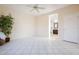 Bedroom with tile floors, access to bathroom, and ceiling fan at 41515 N Chase Oaks Way, Anthem, AZ 85086