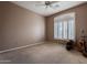 Bedroom with carpet, ceiling fan and large window with shutters at 41515 N Chase Oaks Way, Anthem, AZ 85086