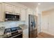 Stainless steel appliances and granite countertops in kitchen at 41515 N Chase Oaks Way, Anthem, AZ 85086