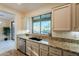 Kitchen sink and granite countertops with backyard view at 41515 N Chase Oaks Way, Anthem, AZ 85086