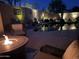 Relaxing pool area at night with fire pit and comfortable seating at 41515 N Chase Oaks Way, Anthem, AZ 85086