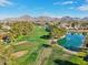 Beautiful aerial view of the golf course and lake surrounded by mature trees and mountain views at 5122 N 31St Way # 244, Phoenix, AZ 85016