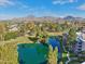Scenic aerial view of community lake and golf course with mountain views in the background at 5122 N 31St Way # 244, Phoenix, AZ 85016