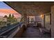 Balcony with chairs and views of surrounding buildings, trees, and a colorful sunset sky at 5122 N 31St Way # 244, Phoenix, AZ 85016