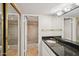 Bathroom featuring granite countertops and a shower with a glass door at 5122 N 31St Way # 244, Phoenix, AZ 85016