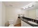 Powder room featuring stylish vanity with stone countertop and adjacent toilet at 5122 N 31St Way # 244, Phoenix, AZ 85016