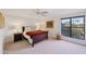 Bedroom features a ceiling fan, nightstands, and large windows with natural light at 5122 N 31St Way # 244, Phoenix, AZ 85016
