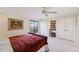 Bright bedroom with a ceiling fan, built-in desk, and large window with a view at 5122 N 31St Way # 244, Phoenix, AZ 85016