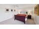 Cozy bedroom featuring a wooden bed frame, bedside tables, and decorative wall art at 5122 N 31St Way # 244, Phoenix, AZ 85016