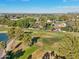 Aerial view of a well maintained golf course with sand traps and players on the green at 5122 N 31St Way # 244, Phoenix, AZ 85016