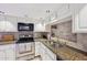 Galley kitchen with stainless steel appliances, granite counters and tiled backsplash at 5122 N 31St Way # 244, Phoenix, AZ 85016