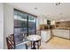 Bright kitchen area with white cabinets, granite counters, tile backsplash, and adjacent breakfast nook at 5122 N 31St Way # 244, Phoenix, AZ 85016