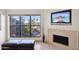 Bright living space with fireplace, and a large window overlooking a serene exterior view at 5122 N 31St Way # 244, Phoenix, AZ 85016