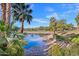 Scenic view of a pond reflecting palm trees and foliage, creating a serene atmosphere at 5122 N 31St Way # 244, Phoenix, AZ 85016