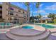 Community pool area features a spa, pool, and lounge chairs for relaxing in the sun at 5122 N 31St Way # 244, Phoenix, AZ 85016